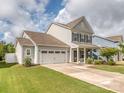 Well-maintained two-story home with a two-car garage, lush lawn, and inviting front porch at 4205 Bent Green Ln, Monroe, NC 28112