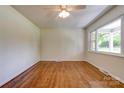 Bright bedroom with hardwood floors, ceiling fan, and large windows at 504 Forest Ridge Dr, Shelby, NC 28152