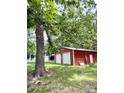 Spacious red outbuilding with two roll-up doors offering plenty of storage space at 511 Eastwood Dr, Albemarle, NC 28001