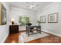 Bright home office featuring a large window, hardwood floors, and classic decor at 5214 Polo Gate Blvd, Charlotte, NC 28216