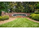 Elegant Wyndham Hall sign, framed by brick wall and vibrant, colorful flowerbed display at 552 Wyndham Ln, Marvin, NC 28173