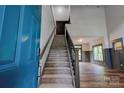 Bright entryway featuring stairs with iron railing, hardwood floors, and a view of the living area at 600 S Cline Ave, Newton, NC 28658