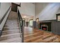 Spacious living room featuring fireplace, wood-look floors, high ceilings, and large windows at 600 S Cline Ave, Newton, NC 28658