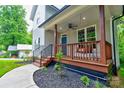 Inviting covered porch with a porch swing, railing, and stairs, perfect for relaxation at 600 S Cline Ave, Newton, NC 28658