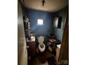Compact bathroom featuring a toilet, sink, and overhead lighting at 618 Douglas St, Shelby, NC 28150