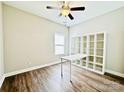 Bright bedroom with wood flooring, a ceiling fan, and a white shelving unit with a desk at 664 Cape Fear St, Fort Mill, SC 29715