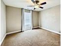 Cozy bedroom featuring neutral walls, carpet, and a ceiling fan with a window and blinds at 664 Cape Fear St, Fort Mill, SC 29715