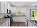Modern kitchen with granite countertops, stainless appliances and white cabinets at 687 Cape Fear St, Fort Mill, SC 29715