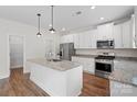 Spacious kitchen features stainless appliances, white cabinets, and granite countertops at 687 Cape Fear St, Fort Mill, SC 29715