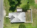 Aerial view showcasing the home's roof, fenced backyard, and surrounding greenery at 711 Wood St, Albemarle, NC 28001
