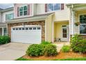 Two-story townhouse with a beige facade, stone accents, and a well-manicured lawn at 809 River Park Rd, Belmont, NC 28012