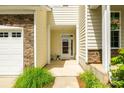 Townhouse front door with stone accents and adjacent two-car garage at 809 River Park Rd, Belmont, NC 28012