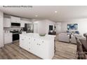 Open-concept living space with a kitchen island, stainless appliances, and an adjacent living area with stylish furniture at 964 Pemberley St # 3193, Lancaster, SC 29720
