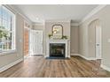 Bright living room with a fireplace, wood floors, and access to the outdoors at 110 Dime Ln, Mooresville, NC 28117