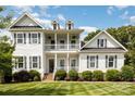 Beautiful two-story home featuring a double porch, black shutters and a well-kept lawn at 112 S Shore Dr, Belmont, NC 28012