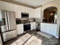 Well-lit kitchen with stainless steel appliances, granite countertops, and white cabinetry, exuding a modern and clean aesthetic at 1139 Drummond Ln, Matthews, NC 28104