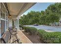 Inviting front porch area with outdoor seating, manicured bushes, and views of the neighborhood at 117 Marakery Rd # B, Mooresville, NC 28115