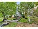 Two-story home nestled among trees with a sidewalk and mailbox in view at 132 E Morehouse Ave, Mooresville, NC 28117
