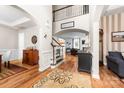 Elegant foyer with hardwood floors, staircase, and archways leading to living areas at 143 Heywatchis Dr, Mooresville, NC 28115