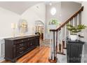 Bright foyer featuring hardwood floors, staircase, and arched entryway to the home's living spaces at 143 Heywatchis Dr, Mooresville, NC 28115