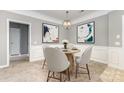 Charming dining room with round table, seating for four, updated lighting, and modern artwork at 14857 Santa Lucia Dr, Charlotte, NC 28277
