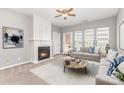 Bright living room features a fireplace, three windows, and a comfortable couch with stylish pillows at 14857 Santa Lucia Dr, Charlotte, NC 28277