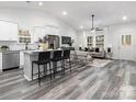 Open-concept living space features modern furnishings, lots of windows, and seamless access to a gourmet kitchen at 1604 N Main St, Mount Holly, NC 28120