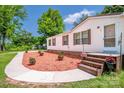 Charming manufactured home featuring a well maintained yard, and warm curb appeal at 161 Crystal Bay Dr, Mooresville, NC 28115