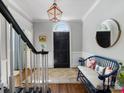 Foyer features hardwood floors, a bench, and access to the staircase at 161 Perrin Pl, Charlotte, NC 28207