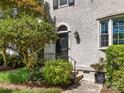 Close up of the front door with decorative details and lush landscaping at 161 Perrin Pl, Charlotte, NC 28207