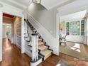 Hallway with hardwood floors and a view of the dining room at 161 Perrin Pl, Charlotte, NC 28207