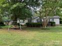Landscaped front yard with swing set and charming single-story home, great curb appeal at 1925 Mt Hope Church Rd, Salisbury, NC 28146