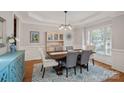 Formal dining room featuring elegant furnishings, wainscoting, and a large window at 19679 Wooden Tee Dr, Davidson, NC 28036