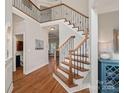 Elegant foyer with hardwood floors, wrought iron staircase, and views into other living spaces at 19679 Wooden Tee Dr, Davidson, NC 28036
