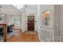 Bright foyer featuring hardwood floors, a decorative niche, and a view of the dining room at 19679 Wooden Tee Dr, Davidson, NC 28036