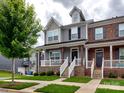 Inviting townhouse exterior with a front porch, stone accents, neat landscaping, and sidewalk appeal at 2001 Laurel Village Cir, Belmont, NC 28012