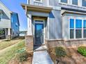 Inviting front entrance with a beautiful glass-paneled door and brick accents, enhancing the curb appeal at 2001 Laurel Village Cir, Belmont, NC 28012
