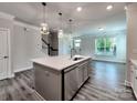 Modern kitchen with island sink, pendant lighting, and stainless steel appliances blending style and function at 2001 Laurel Village Cir, Belmont, NC 28012