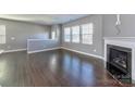 Inviting living room featuring gleaming hardwood floors and a charming fireplace, perfect for relaxation and gatherings at 2001 Laurel Village Cir, Belmont, NC 28012