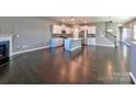 Spacious living area with rich hardwood floors, a cozy fireplace, and an open layout with abundant natural light at 2001 Laurel Village Cir, Belmont, NC 28012
