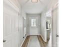 Inviting hallway with wood floors leading to an open-concept living space and plenty of light at 2005 Grimley Ln, Fort Mill, SC 29707