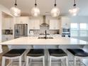 Bright kitchen with stainless steel appliances, a spacious island with seating, and ample counter space at 2048 Turnsberry Dr, Monroe, NC 28112