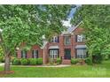 Traditional two-story brick home with manicured lawn and mature trees at 20812 Decora Dr, Cornelius, NC 28031