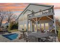 Expansive backyard with a cozy patio, outdoor furniture, and a refreshing pool, perfect for relaxation and outdoor entertainment at 21610 Rio Oro Dr, Cornelius, NC 28031