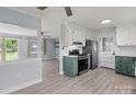 Open kitchen and dining area featuring gray floors, stainless steel appliances, and modern fixtures at 2632 Montford Nw Ave, Concord, NC 28027