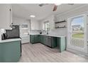 Bright kitchen with light gray floors, two-toned cabinets, a stainless steel dishwasher, and a large window at 2632 Montford Nw Ave, Concord, NC 28027
