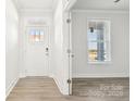 Bright foyer features a door with glass panes, light walls, and luxury vinyl plank flooring at 279 Miramar Dr, York, SC 29745