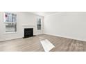 Bright living room with two windows, a fireplace, light walls, and luxury vinyl plank flooring at 279 Miramar Dr, York, SC 29745
