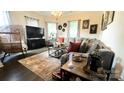 Inviting living room showcasing a comfortable gray sectional sofa, stylish decor, and plenty of natural light at 303 N Main N St, Granite Quarry, NC 28146