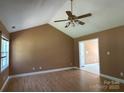 Spacious living room with vaulted ceiling, ceiling fan, neutral walls, and wood-look flooring at 3240 St Vincent Dr, Claremont, NC 28610